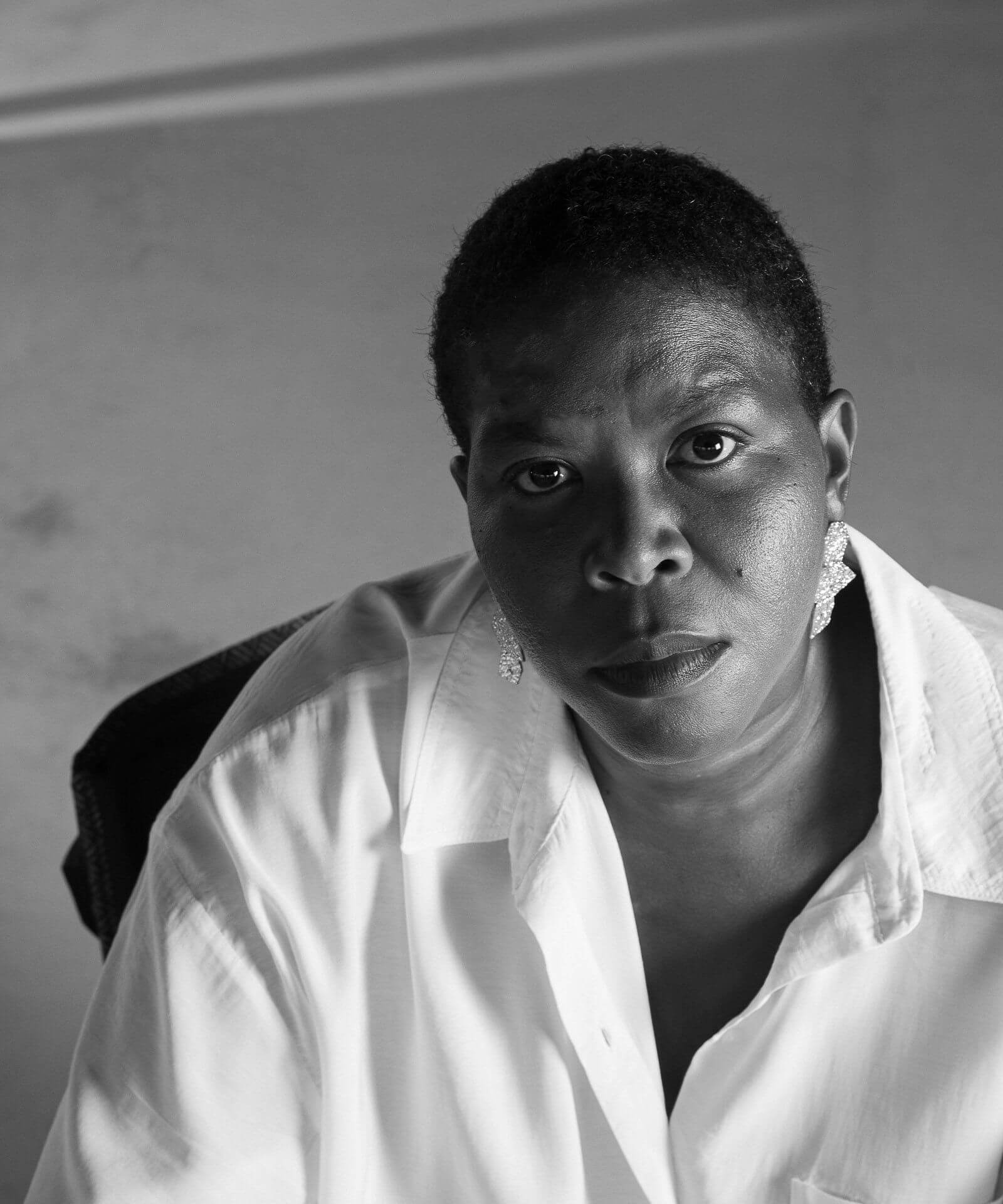 Black and white portrait of Simone Lagrand, looking at the camera, wearing a white shirt.