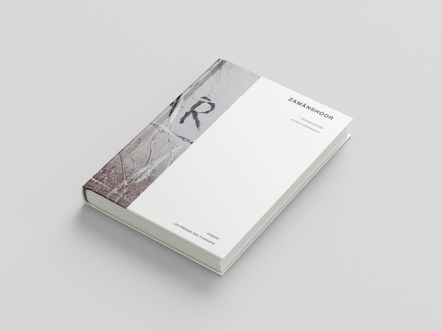 Un livre à couverture rigide intitulé « Zamânshoor » est présenté sur un fond uni. La couverture présente un design minimaliste avec une section texturée et un texte de titre simple sur un fond blanc. Le dos et une partie de la couverture avant présentent une certaine usure artistique.